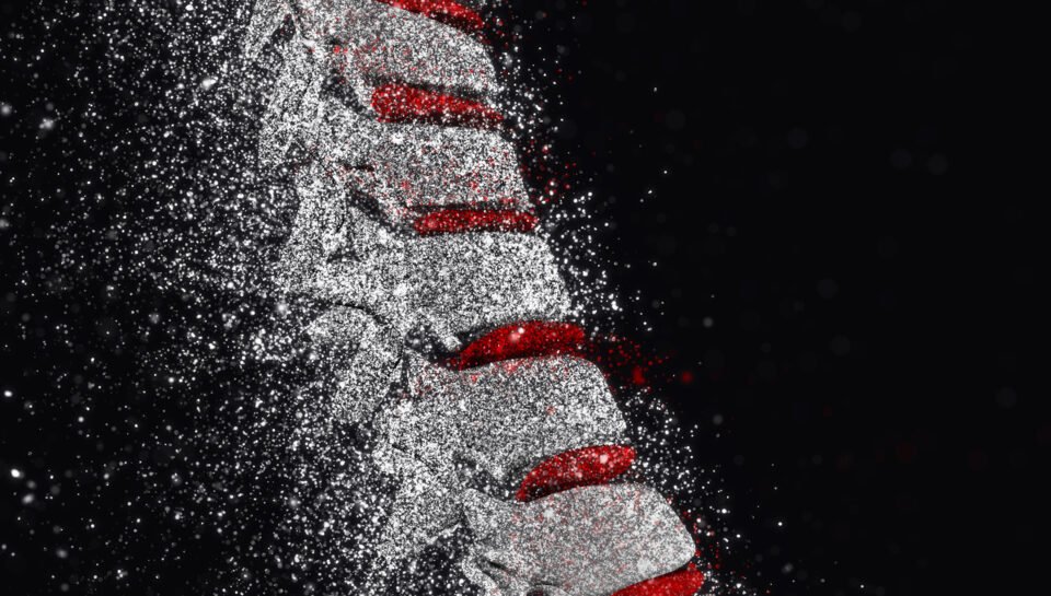 3D render of a spine with disintegration effect